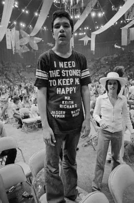Person wearing a t-shirt with text at a crowded event