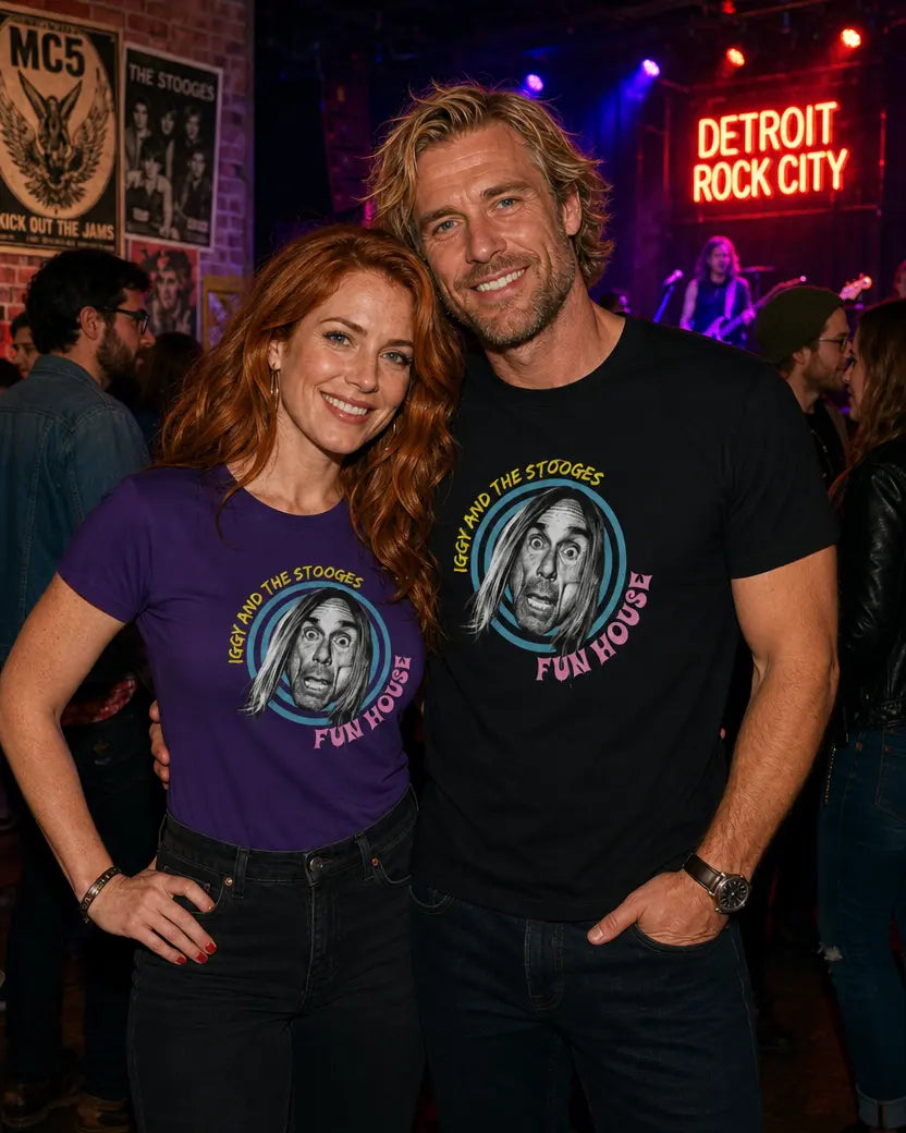 Two people wearing 'The Stooges' t-shirts in a bar setting with 'Detroit Rock City' neon sign.
