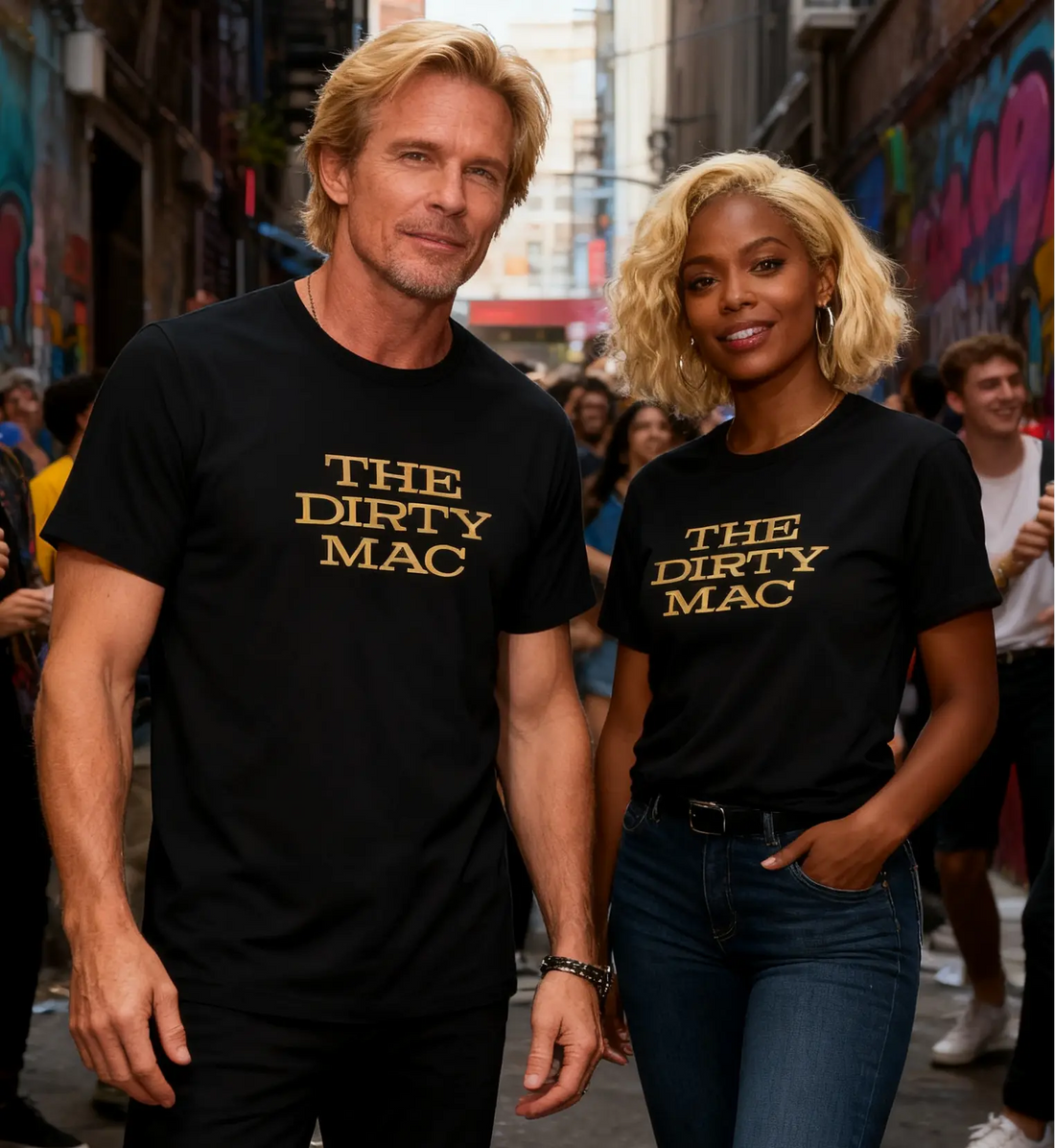 Two people wearing 'The Dirty Mac' t-shirts walking through a graffiti-covered alley.